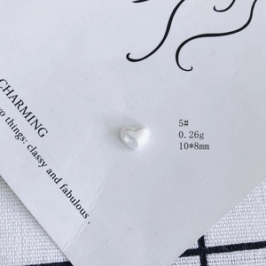 Detailed macro view of 10x8mm white aurora heart resin charm for DIY jewelry and nail art