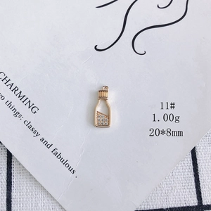 Detailed view of a gold-plated bottle-shaped pendant with white zircon and size 20x8mm