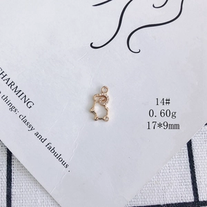 Macro shot of 18K gold plated ram pendant with zircons for jewelry making, 17x9mm size