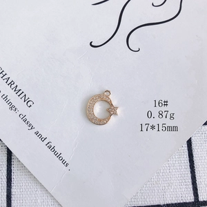 Detail of 14K gold plated moon and star pendant with white zircon micro-pave setting