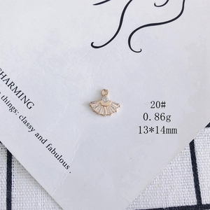 Macro shot of 13x14mm gold-plated fan pendant with zircon stones for DIY jewelry making