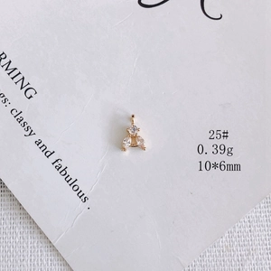 Macro shot of 18K gold plated leaf pendant with white zircon stones on display card
