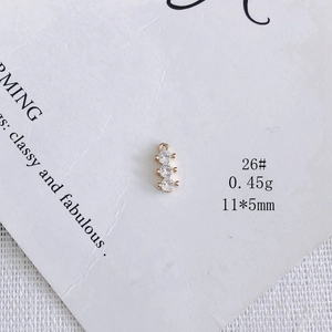 Macro view of a 14k gold plated vertical triple zircon pendant for DIY jewelry making