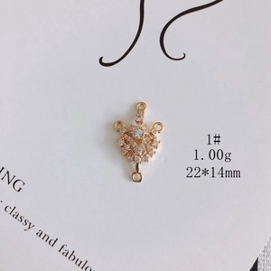 Macro shot of 22x14mm gold-plated flower charm with zircon stones and four link holes