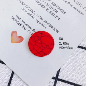 Macro view of 25mm red acrylic round pendant with black spiderweb texture and hole