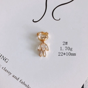 Detailed macro view of a gold-plated bear pendant with sparkling cubic zirconia stones