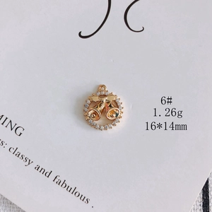 Detail of gold-plated Christmas bell pendant with crystals, 16x14mm size and 1.26g weight