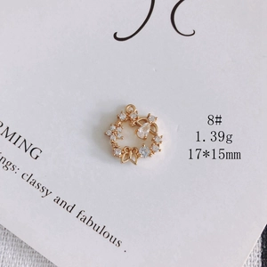 Detail shot of a 17x15mm gold-plated floral pendant with white cubic zirconia stones