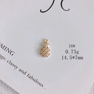Macro shot of 18k gold plated pineapple charm with sparkling white zircon inlay