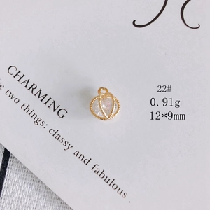 Detail of 12x9mm gold plated hollow cage charm with transparent crystal for DIY jewelry