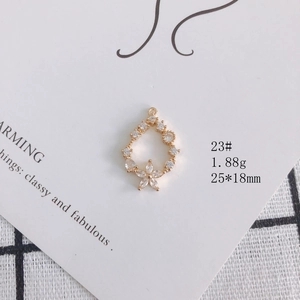 Detailed close-up of 18k gold plated teardrop floral pendant with marquise zircons