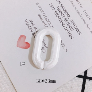 Macro view of creamy white acrylic oval link with marble texture, 38x23mm size