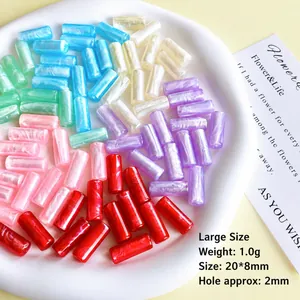 Colorful marble resin cylindrical tube beads 20x8mm displayed on a white ceramic plate