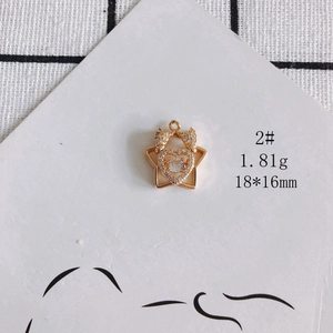 Detail of star and heart hollow pendant in gold finish with white zircon stones