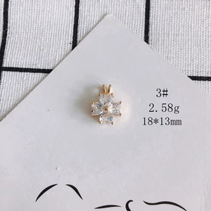 Macro view of a 18k gold plated clover pendant with clear cubic zirconia stones