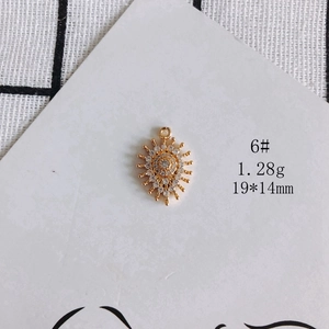 Detailed view of 1.28g gold-plated sunburst charm with zircon inlay for jewelry making