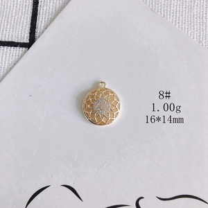 Detail of 14K gold plated hollow floral pendant with white zircon stones, 16x14mm size