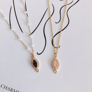 Marquise pendant necklaces with gold plating, zircon, and pearls on minimal art background