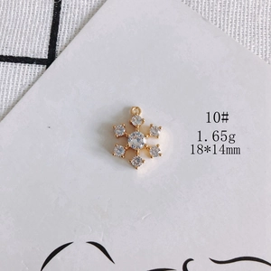 Macro detail of 18*14mm gold-plated snowflake pendant with white cubic zirconia inlay