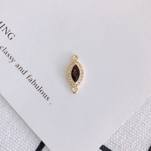Macro detail of marquise zircon resin connector with gold finish for DIY jewelry