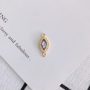 Macro view of marquise-shaped gold opal connector with sparkling zircon stones for DIY jewelry