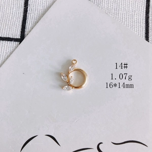 Detail view of 18K gold plated leaf charm with marquise zircon, measuring 16x14mm and 1.07g