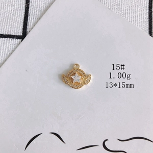 Macro detail of star wings gold pendant with cubic zirconia inlay and measurements