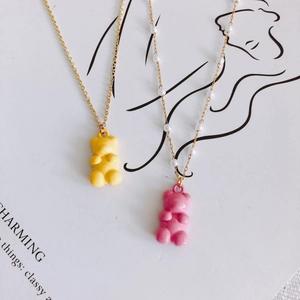 Cute candy-colored resin gummy bear pendants with gold chain and pearl necklace details