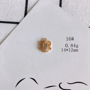 Macro view of 14x12mm hollow heart jewelry pendant with teardrop zircon and gold plating