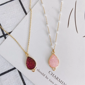 Waterdrop-shaped foil pendants with gold edges and pearl-studded chain necklace