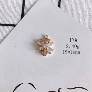 Macro view of gold plated clover pendant with clear cubic zirconia stones and dimensions