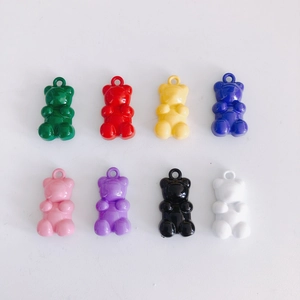 Close-up of resin gummy bear pendants in eight vibrant colors for DIY jewelry making
