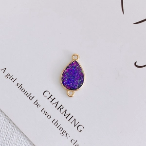 Close-up of teardrop purple crushed stone pendant with gold plated double loop connectors