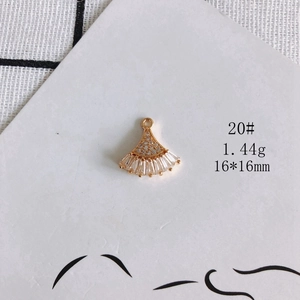 Macro shot of 18k gold-plated fan-shaped pendant with cubic zirconia, 16x16mm size