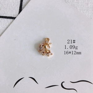 Detailed macro view of a 16x12mm 18K gold plated unicorn pendant with clear zircon stones