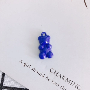 Macro detail of royal blue resin gummy bear pendant for DIY jewelry crafting