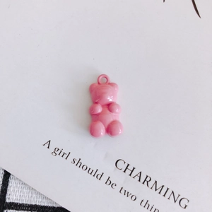 Detailed view of a pink resin gummy bear charm with a metal loop for DIY jewelry making