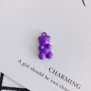 Close-up of a purple resin bear pendant with built-in ring for DIY jewelry making
