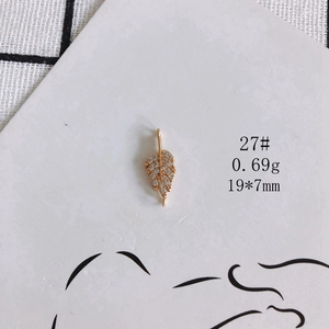 Detailed view of gold leaf charm pendant with cubic zirconia for jewelry making