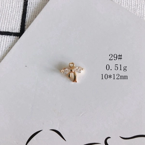 Detail of 14K gold plated bow pendant with clear crystals for DIY jewelry making