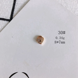 Detail of a 18K gold plated hollow heart charm with pavé cubic zirconia for DIY jewelry