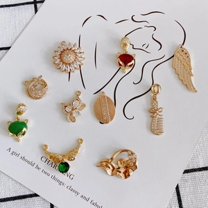 Gold-plated brass charm pendants with sparkling zircons in floral and animal designs