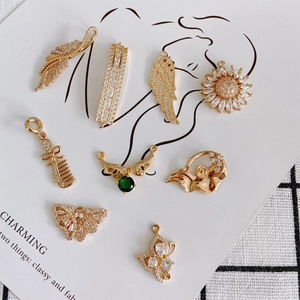 Golden plated brass charms set with cubic zirconia in butterfly and sunflower designs