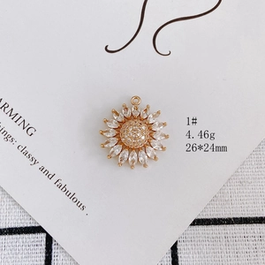 Detail view of sunflower pendant featuring gold-plated copper and marquise zirconia