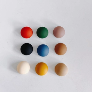 Flat lay of 14mm matte resin half-round charms in nine assorted colors for DIY phone cases