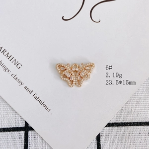 Macro view of a gold plated butterfly pendant with pavé cubic zirconia for DIY jewelry