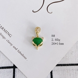 Detailed view of fox pendant with green gemstone and white zircon in gold finish