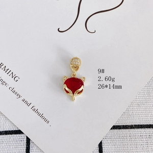 Macro shot of 14K gold plated fox pendant with red agate and zircon, 26x14mm size