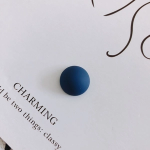 Macro view of 14mm navy blue matte resin semi-circle charm on minimalist white card