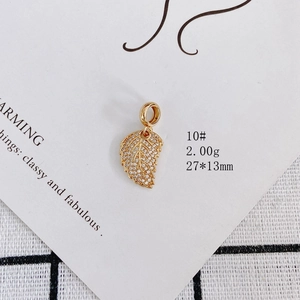 Macro shot of 18k gold plated leaf pendant with white pavé cubic zirconia 27x13mm